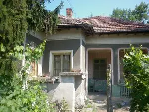 An old rural house with nice plot of land located near the center of a big village near forest and river