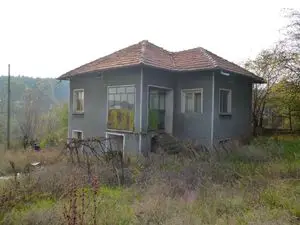 An old rural house located in a quiet village near forest