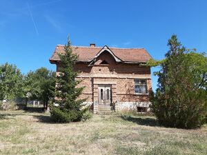 Old rural house with garage and barn located in a village