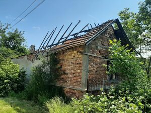 Plot of land with an old damaged rural house close to forest
