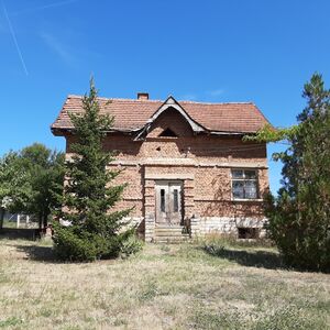 Old rural house with garage and barn located in a village